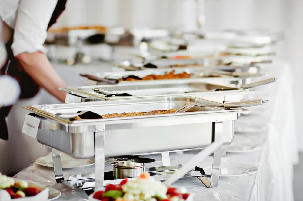 A Something Different staff member serving a catered meal